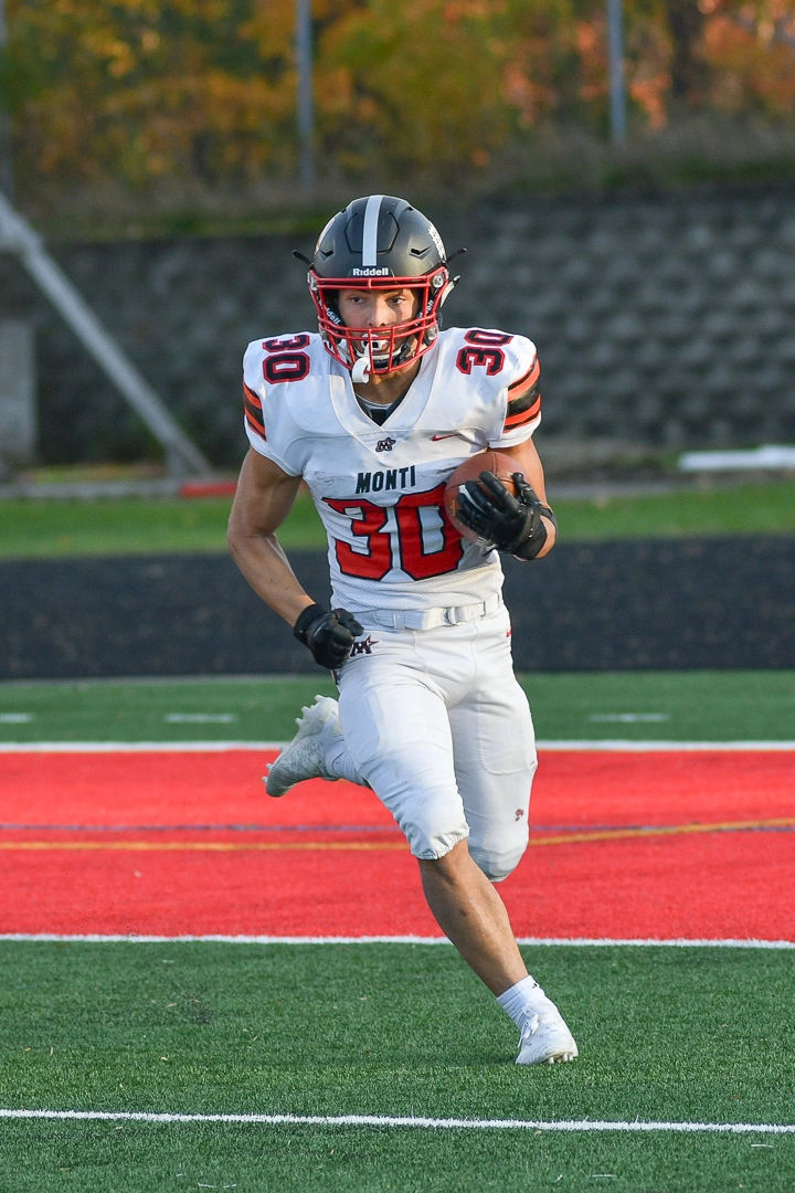 Monticello high school football player runs with the ball during a Minnesota game day