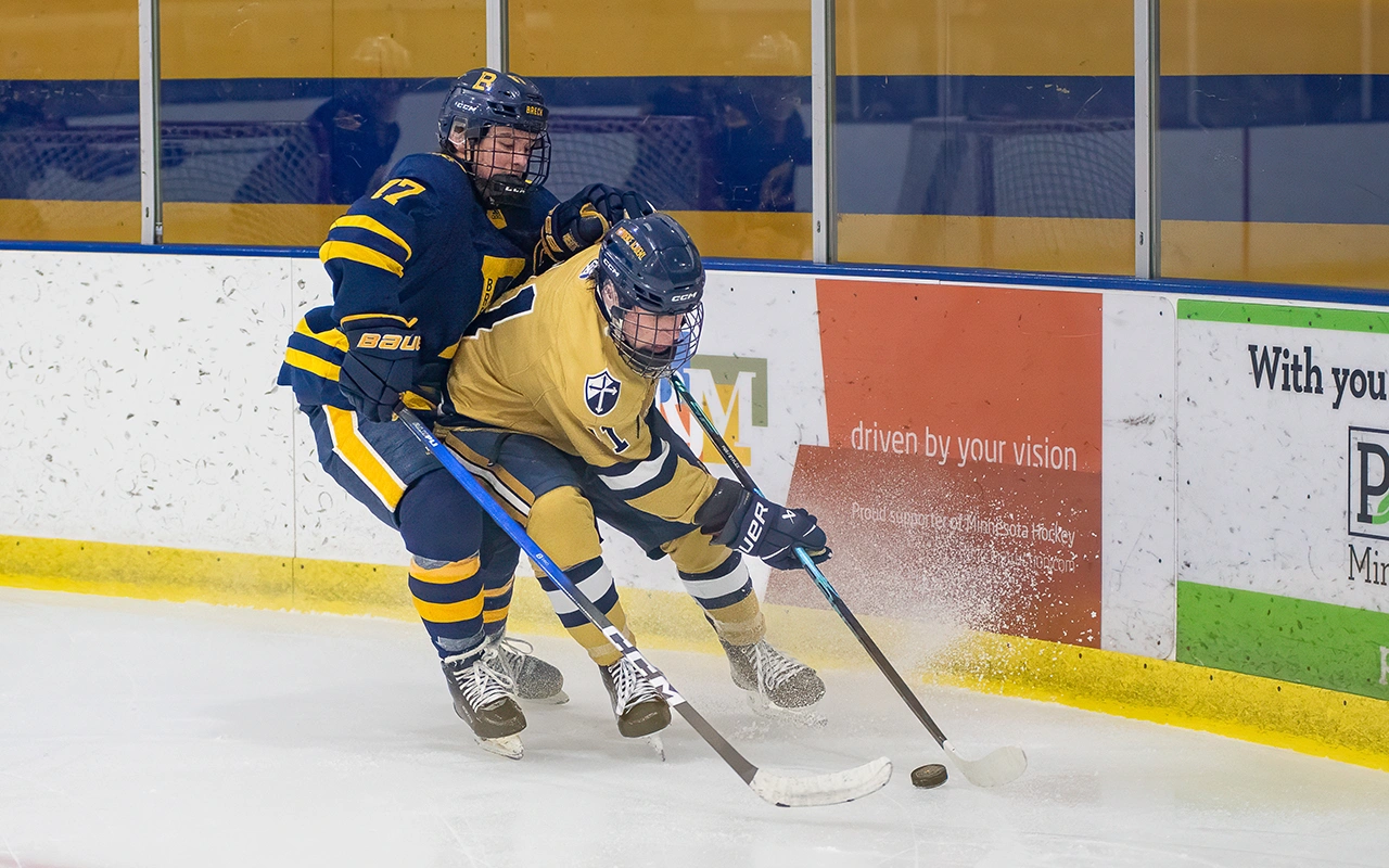 Youth hockey players battle for the puck