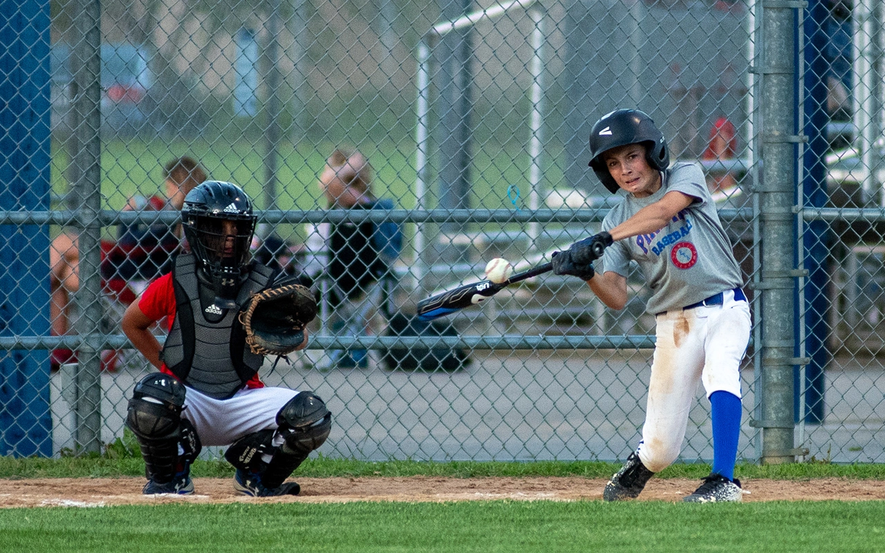 Pine Tar youth baseball batter makes contact at the plate during a Minnesota game day